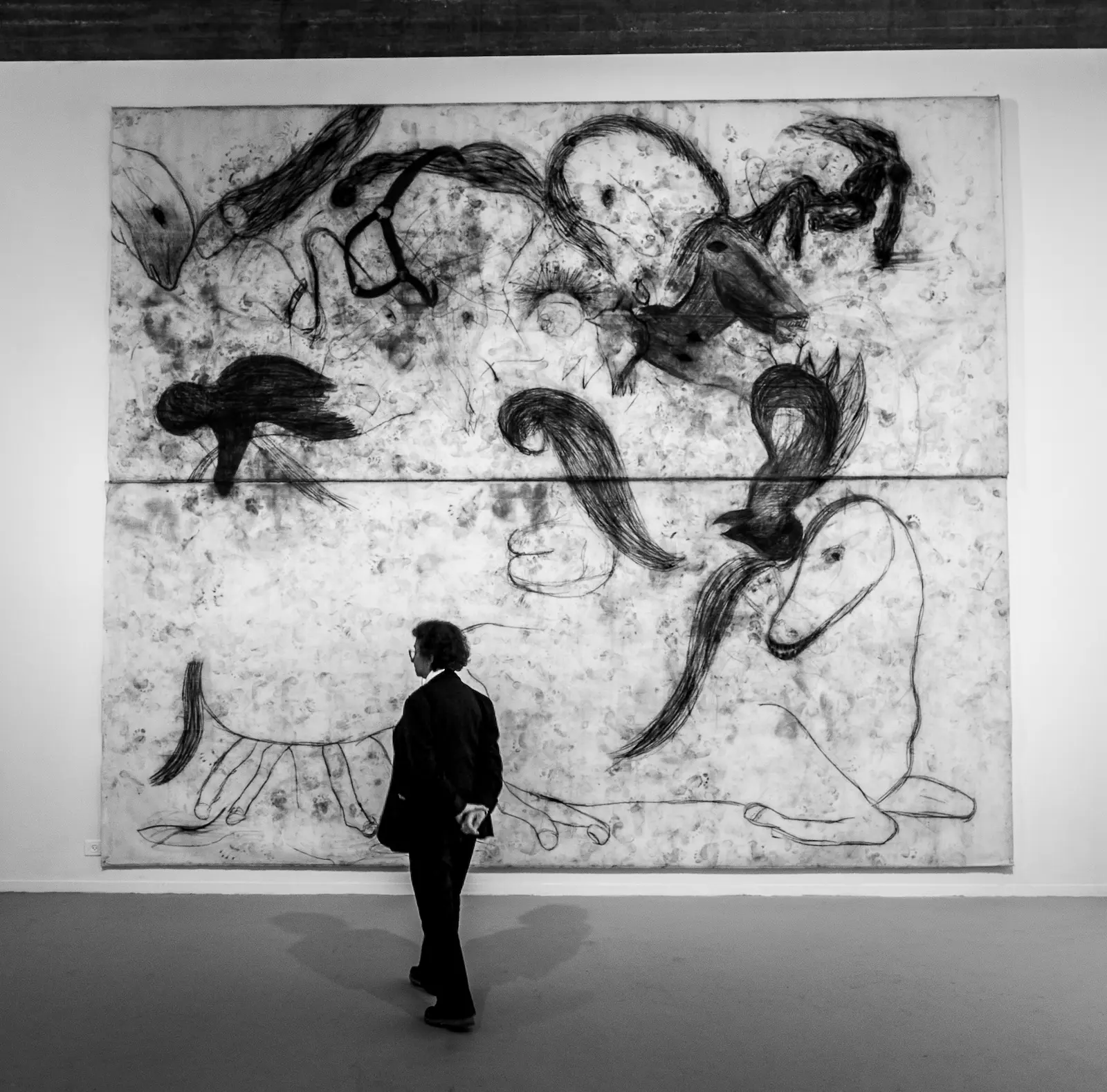 Museum employee standing before large drawing by Michel Platnic, Museum of Israel Jerusalem