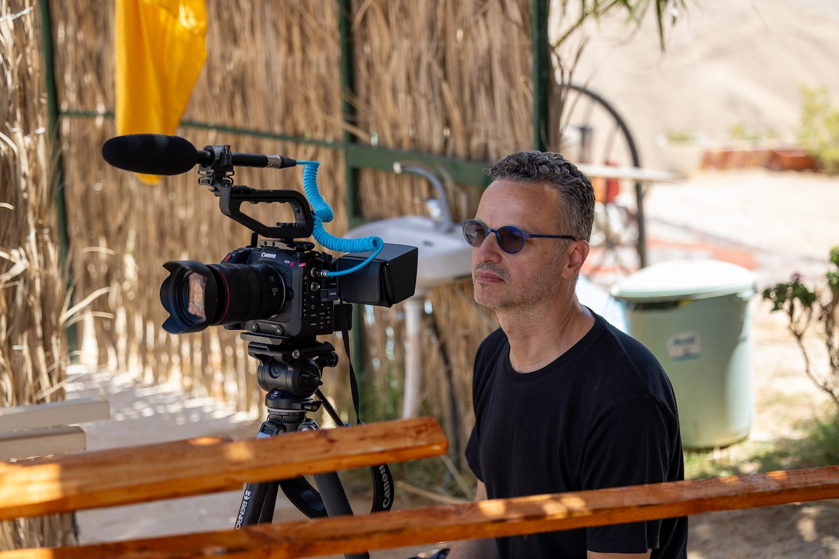 Filmmaker with camera at Rashayda camp, Judean Desert