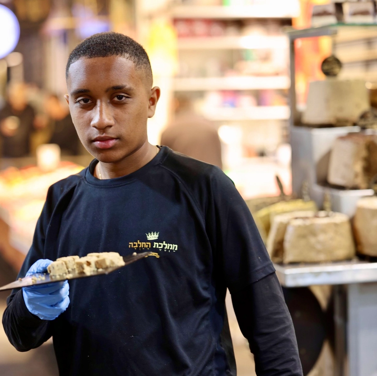 Young man with halva tray at Mahane Yehuda market