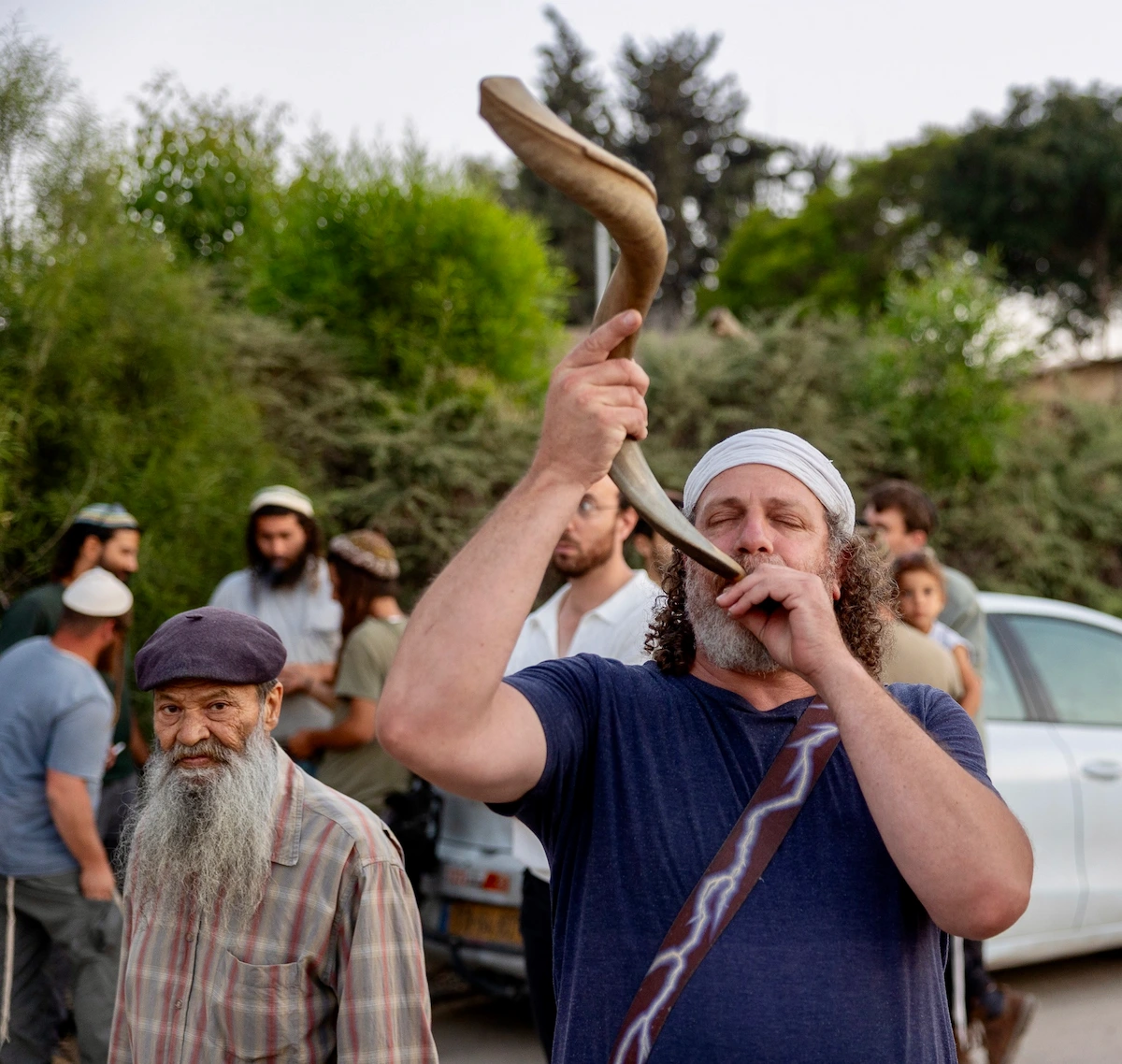 Man blowing a shofar at a funeral in southern Israel