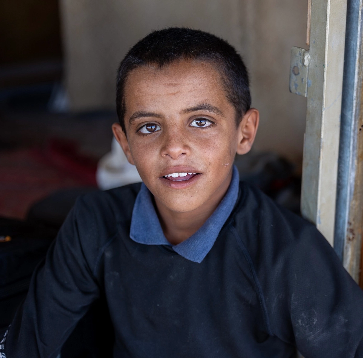 Bedouin boy in doorway, Rashayda tribe, Judean Desert