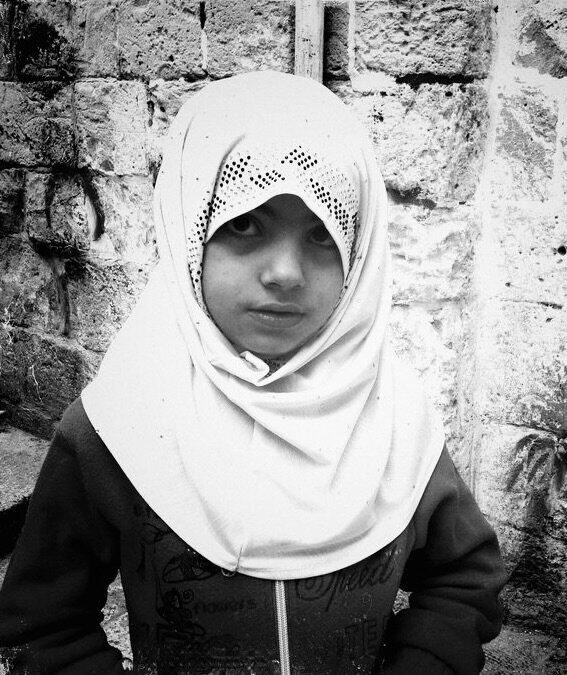 Portrait of a girl in a hijab against a stone wall, Old City, Jerusalem