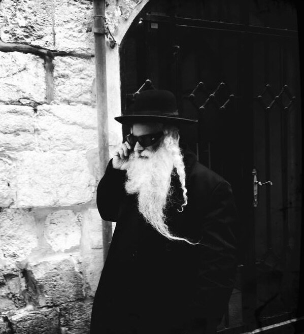 A man with a long white beard and hat on the phone, Old City, Jerusalem