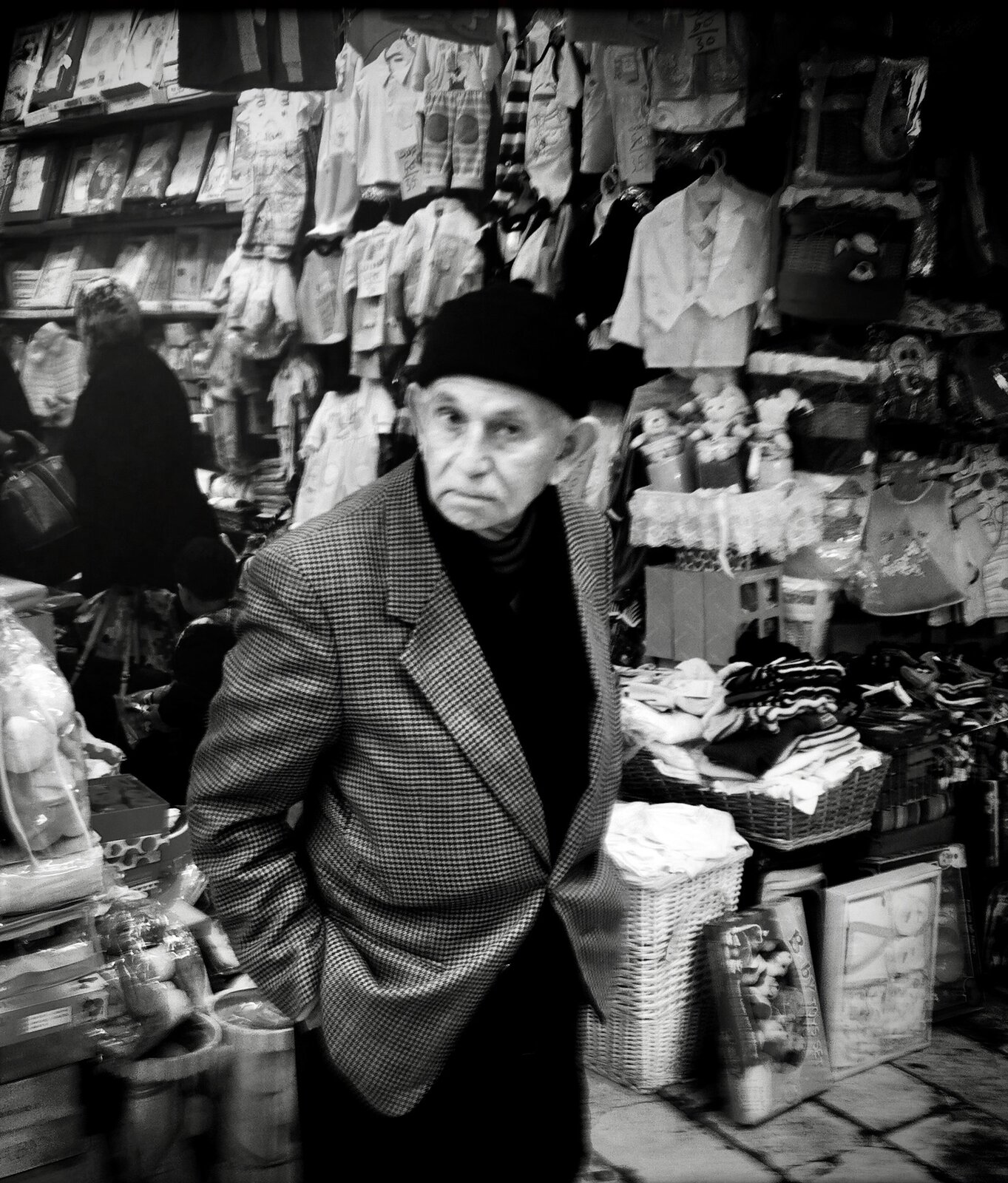 An elderly shopkeeper standing in his children's clothing stall, Old City, Jerusalem