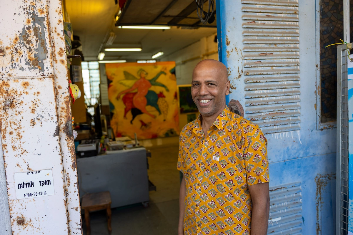 Artist Chanchal Banga at his studio doorway in Jaffa
