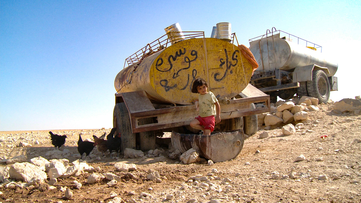 Child at water tank, Rashayda camp