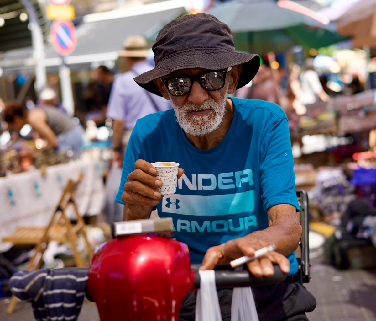 Man with coffee and cigarette at Jaffa flea market
