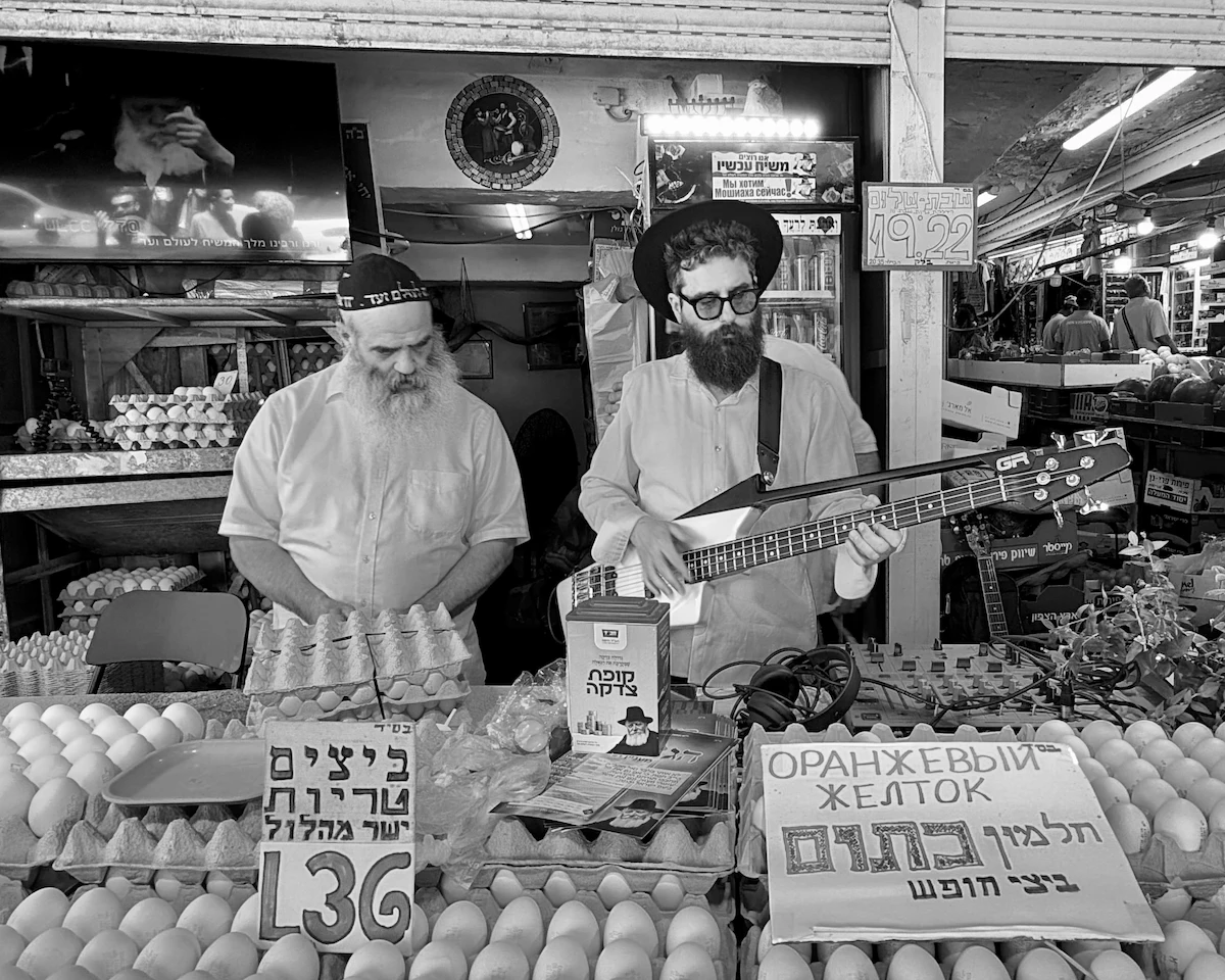 Bass guitar player at egg stall, Talpiot Market, Haifa
