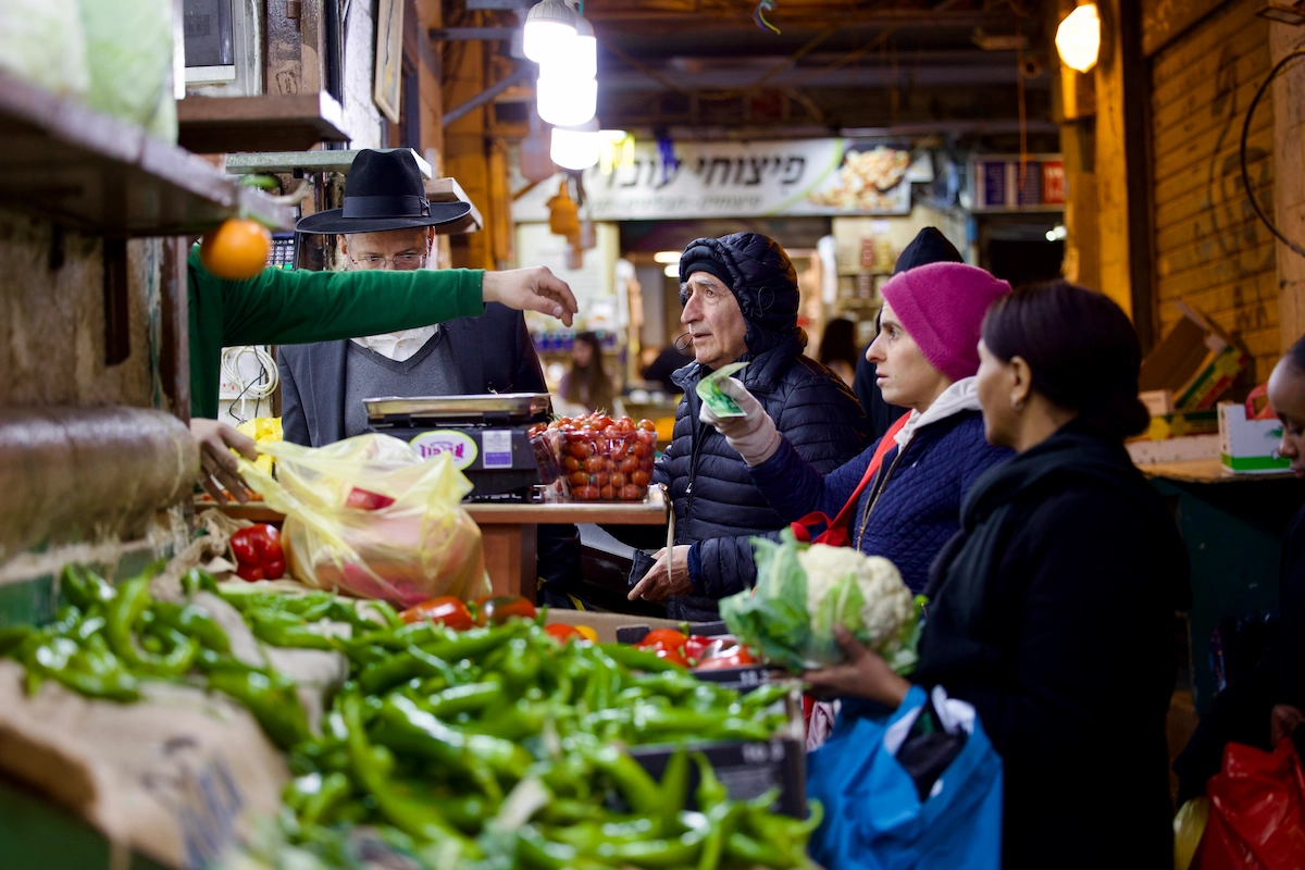 Vendor and customers at Mahane Yehuda market Jerusalem