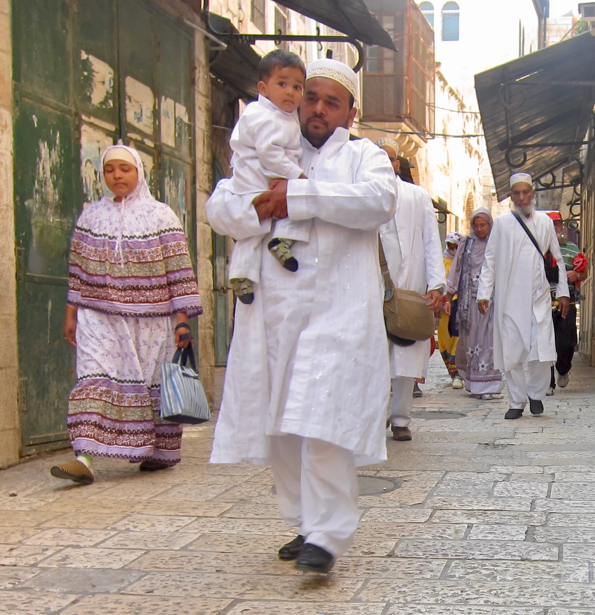 Muslim family walking through the Muslim Quarter, Old City Jerusalem