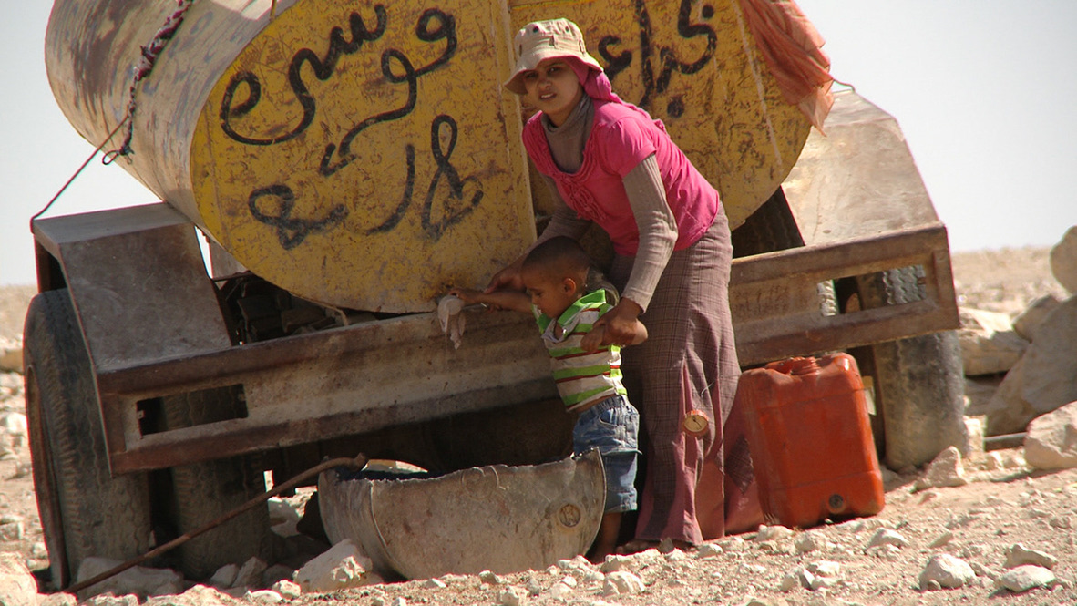 Mother and child at water truck