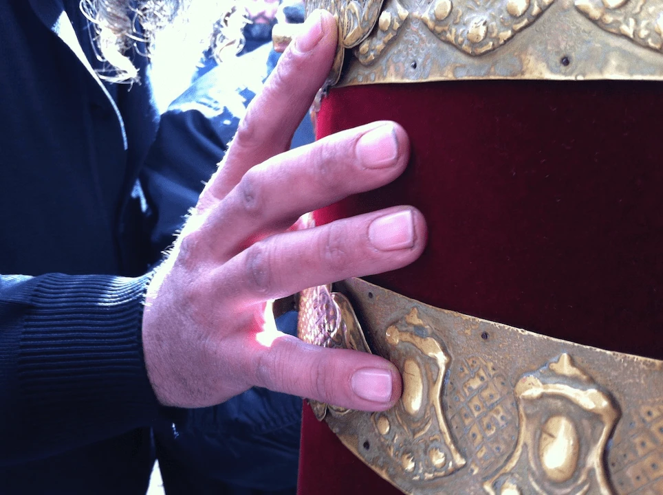 Hand on Torah scroll breastplate, Judean Desert
