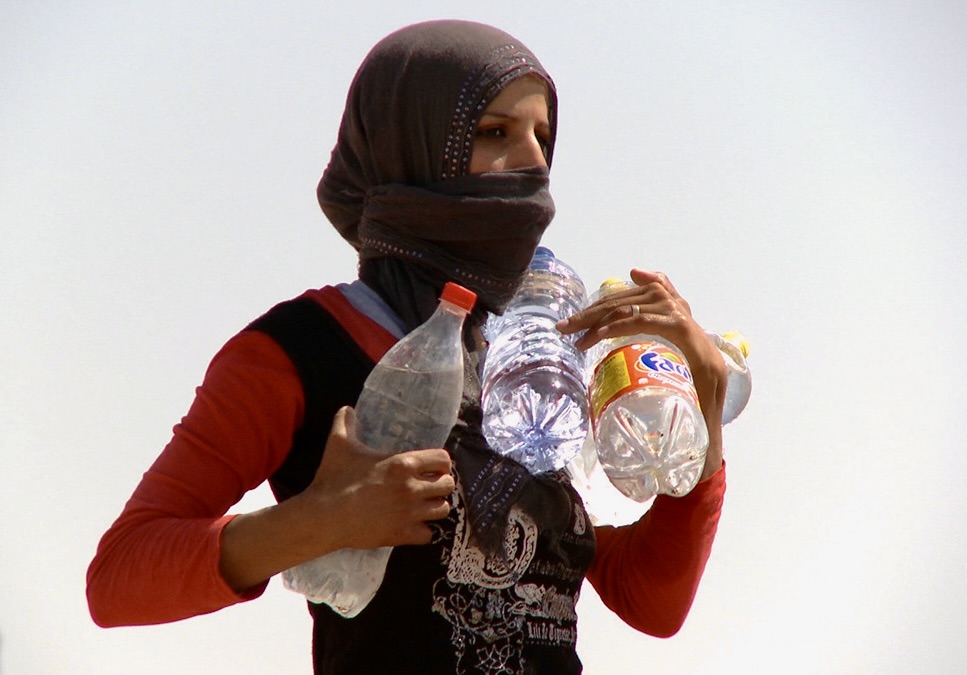 Woman carrying water bottles