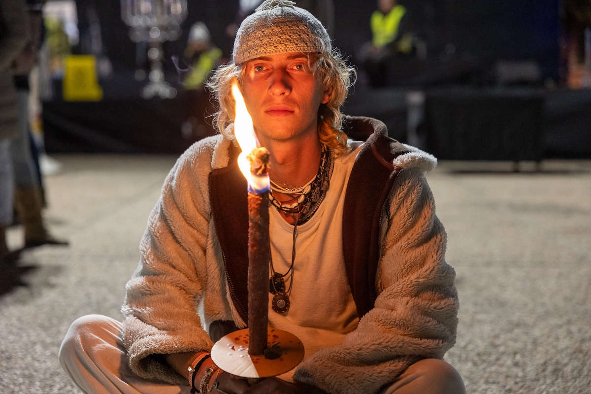 Young man holding a candle at a Tel Aviv hostage rally